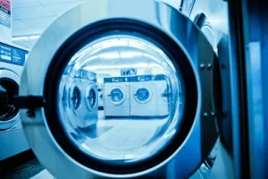 View inside a laundromat showing a row of machines, highlighting the best commercial laundry equipment and brands