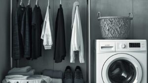 A neatly organized laundry area with clothes hanging and a washing machine.
