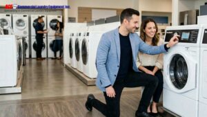 Business owners reviewing commercial laundry equipment in a showroom.