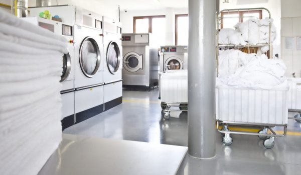 Big industrial laundry washing machines clean zone bright modern